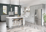 Modern kitchen with grey cabinets, stainless steel appliances, and a white island.