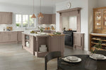Modern kitchen with wooden cabinets, island, and dining area.
