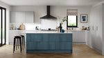 Modern Zurfiz kitchen with a blue island, light grey cabinets, and wooden flooring.